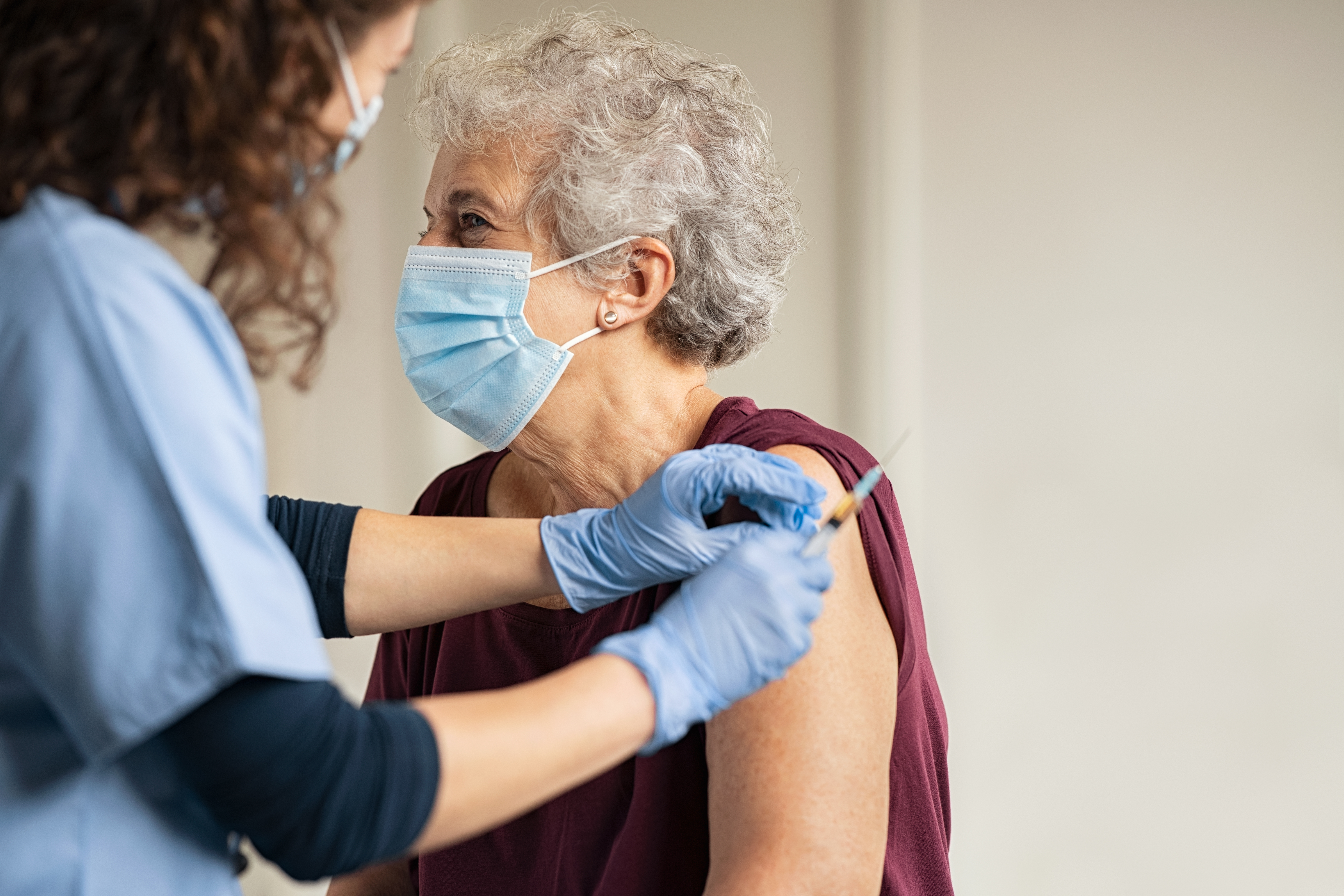 Mediziner impft ältere Patientin